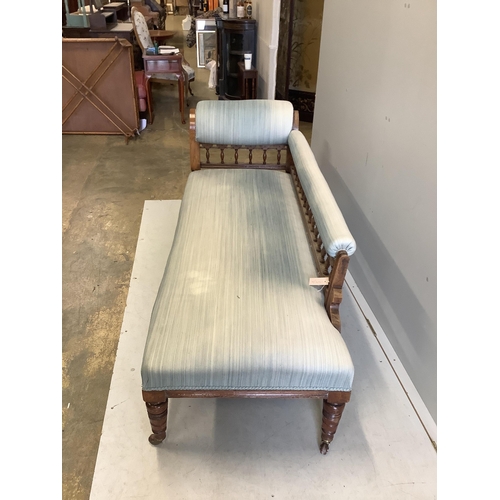 44 - An Edwardian oak chaise longue, upholstered in green cord, on turned and carved legs fitted castors,... 