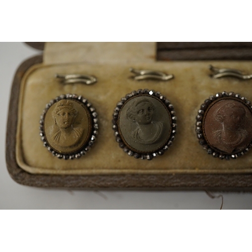 465 - A cased set of 6 late Victorian carved lava buttons with cut steel borders, each carved with a class... 