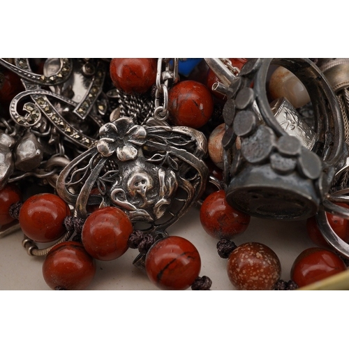 941 - A mixed group of silver jewellery, including two charm bracelets, an Art Nouveau-style pendant; a po... 