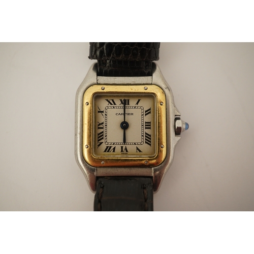 125 - A lady's steel and gold Cartier Panthere quartz wrist watch, now on an associated leather strap, but... 