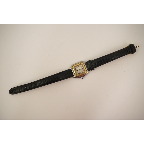 125 - A lady's steel and gold Cartier Panthere quartz wrist watch, now on an associated leather strap, but... 