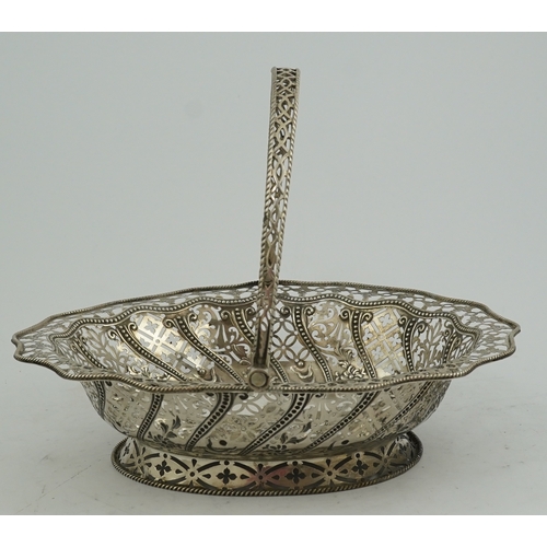 13 - A George III pierced repousse silver cake basket, of oval form, with wavy border and engraved armori... 