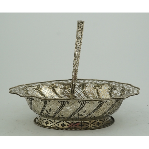 13 - A George III pierced repousse silver cake basket, of oval form, with wavy border and engraved armori... 