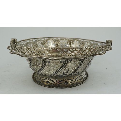 13 - A George III pierced repousse silver cake basket, of oval form, with wavy border and engraved armori... 