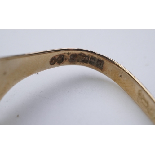 158 - Two gold rings, comprising: a gold wedding band, size U/V, stamped 18CT, gross weight 10.1 grams; an... 