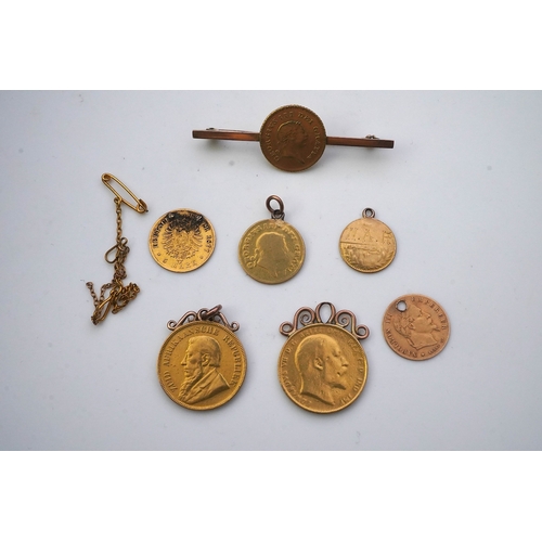 162 - Seven assorted mounted or drilled gold coins, comprising: an 1898 gold 1 pound coin; a 1902 sovereig... 