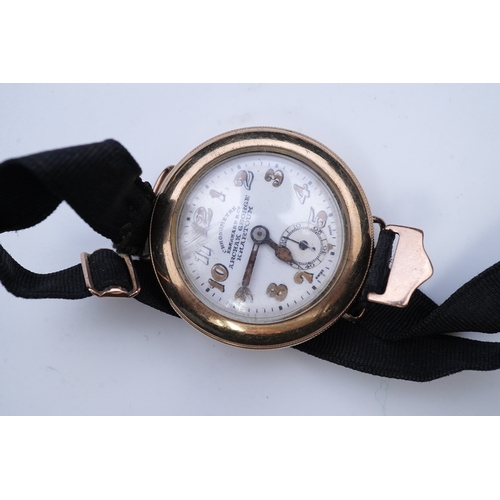 168 - A collection of jewellery, comprising: a gold watch with a black fabric strap, dial signed Archak Ge... 