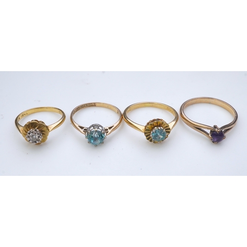 176 - Four rings comprising: a ring set with a circular-cut blue zircon in a faceted border, size M, stamp... 