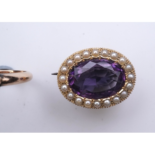 179 - An amethyst brooch and an amethyst mourning ring, early 20th century, comprising: an oval brooch set... 