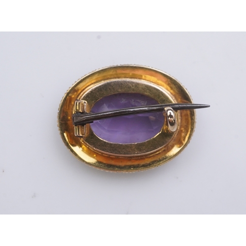 179 - An amethyst brooch and an amethyst mourning ring, early 20th century, comprising: an oval brooch set... 