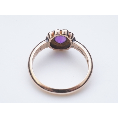 179 - An amethyst brooch and an amethyst mourning ring, early 20th century, comprising: an oval brooch set... 