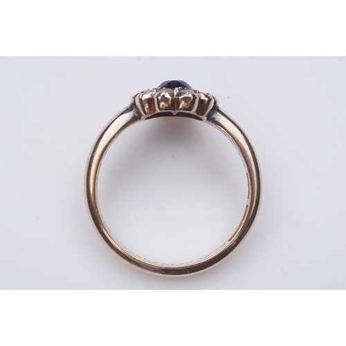 179 - An amethyst brooch and an amethyst mourning ring, early 20th century, comprising: an oval brooch set... 