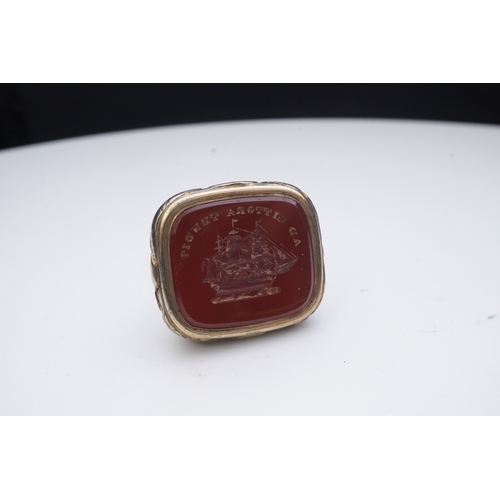 181 - A collection of jewels, comprising: a carnelian fob seal engraved with a ship and the motto 'AD LITT... 