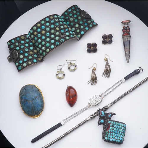 185 - A collection of jewels, comprising: a cuff set with turquoise cabochons; a pendant inlaid with turqu... 