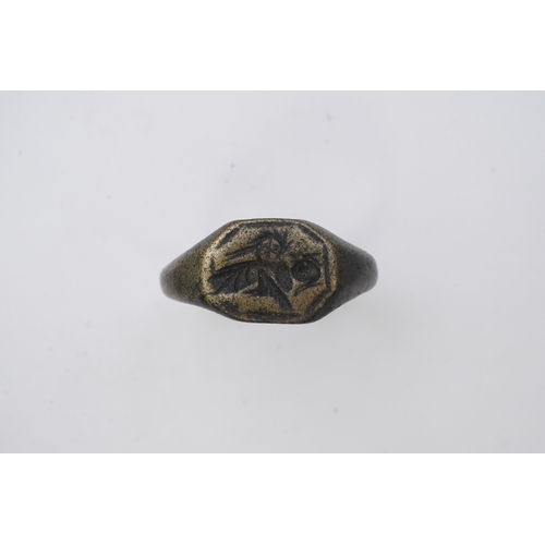 190 - A medieval bronze iconographic ring, France, 15th century, the elongated octagonal central panel eng... 