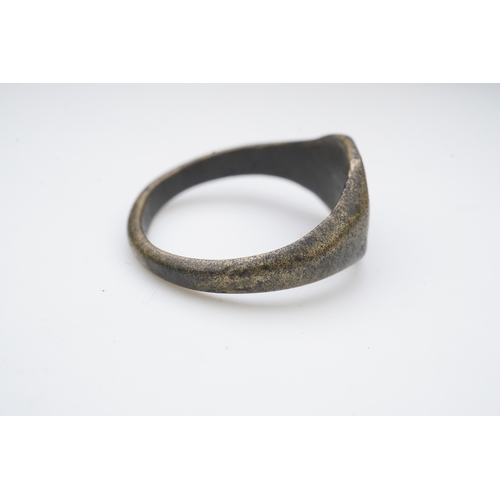 190 - A medieval bronze iconographic ring, France, 15th century, the elongated octagonal central panel eng... 