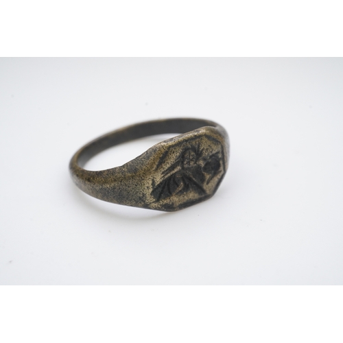 190 - A medieval bronze iconographic ring, France, 15th century, the elongated octagonal central panel eng... 