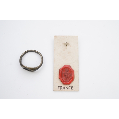 190 - A medieval bronze iconographic ring, France, 15th century, the elongated octagonal central panel eng... 