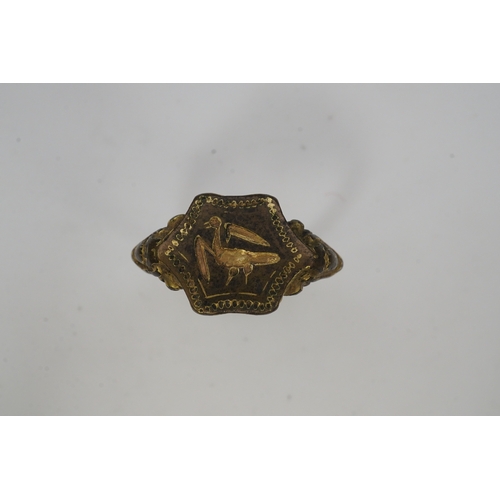 192 - A Tudor bronze signet ring, England, 16th century, the central hexagonal bezel carved with a bird wi... 