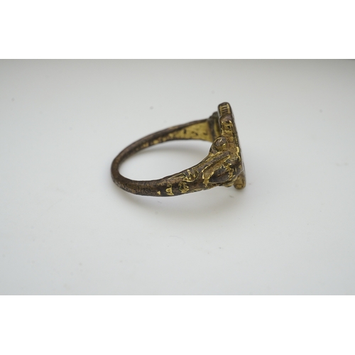 192 - A Tudor bronze signet ring, England, 16th century, the central hexagonal bezel carved with a bird wi... 