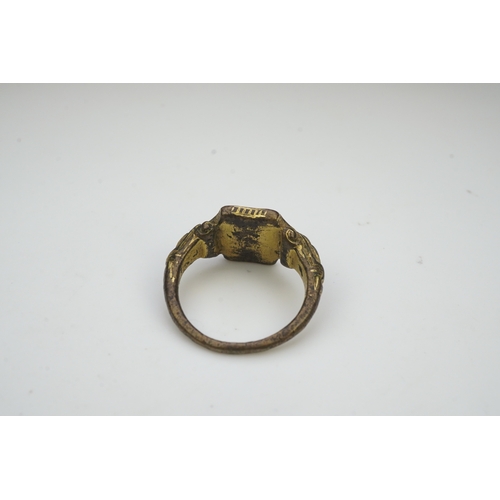 192 - A Tudor bronze signet ring, England, 16th century, the central hexagonal bezel carved with a bird wi... 