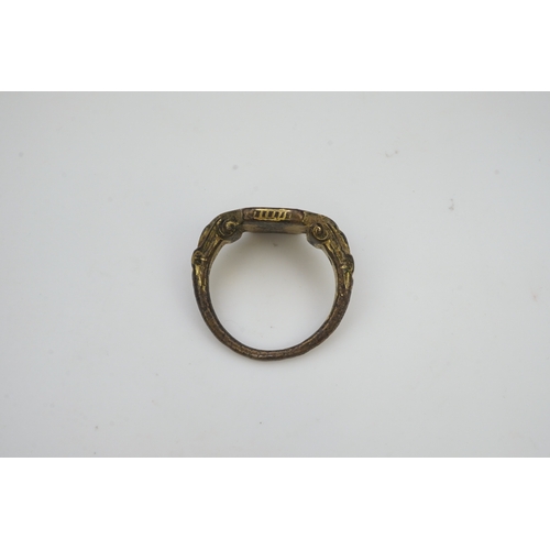 192 - A Tudor bronze signet ring, England, 16th century, the central hexagonal bezel carved with a bird wi... 