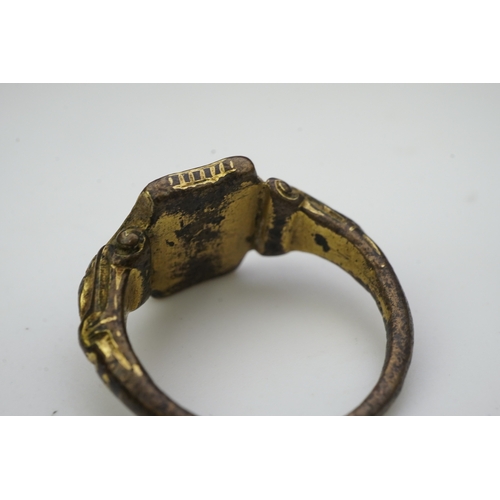 192 - A Tudor bronze signet ring, England, 16th century, the central hexagonal bezel carved with a bird wi... 