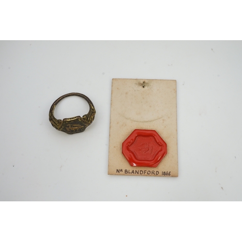 192 - A Tudor bronze signet ring, England, 16th century, the central hexagonal bezel carved with a bird wi... 