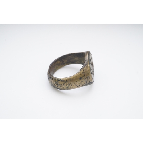 193 - A bronze signet ring, France, 15th/16th century, the circular central panel engraved with a fleur-de... 