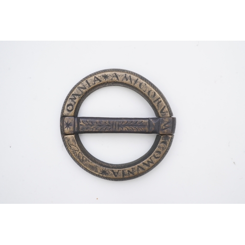 195 - A bronze buckle, 16th-17th century, of circular outline, bearing the inscription 'OMNIA AMICORUM COM... 