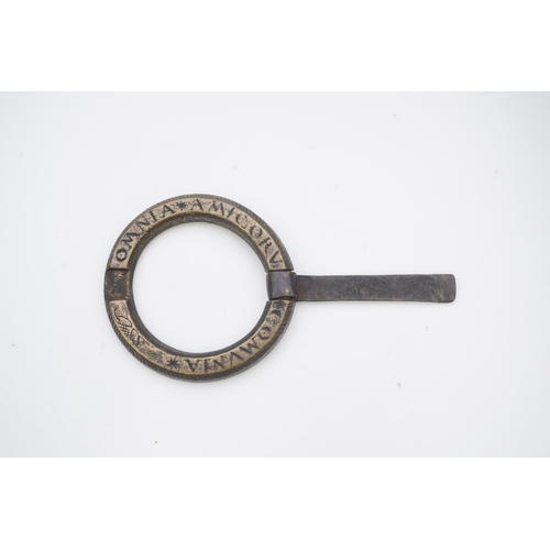 195 - A bronze buckle, 16th-17th century, of circular outline, bearing the inscription 'OMNIA AMICORUM COM... 