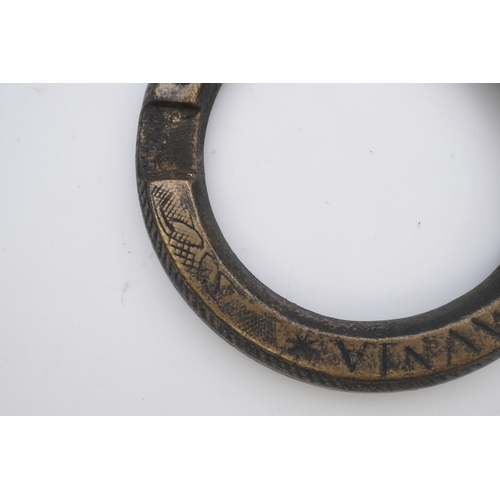 195 - A bronze buckle, 16th-17th century, of circular outline, bearing the inscription 'OMNIA AMICORUM COM... 