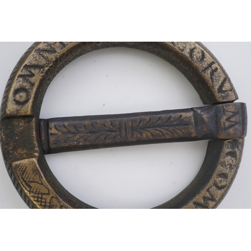 195 - A bronze buckle, 16th-17th century, of circular outline, bearing the inscription 'OMNIA AMICORUM COM... 