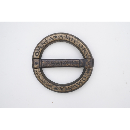 195 - A bronze buckle, 16th-17th century, of circular outline, bearing the inscription 'OMNIA AMICORUM COM... 