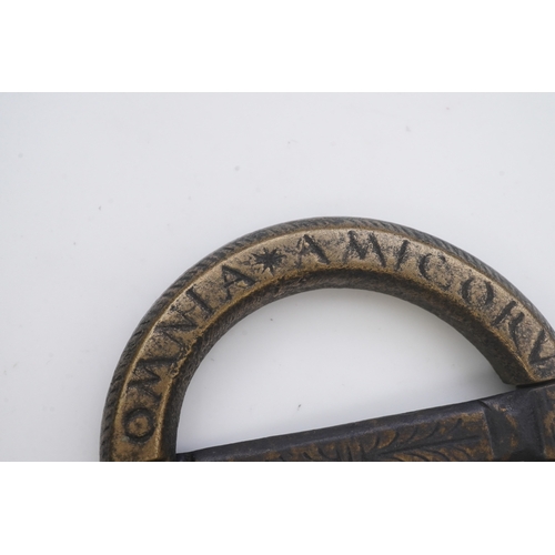 195 - A bronze buckle, 16th-17th century, of circular outline, bearing the inscription 'OMNIA AMICORUM COM... 