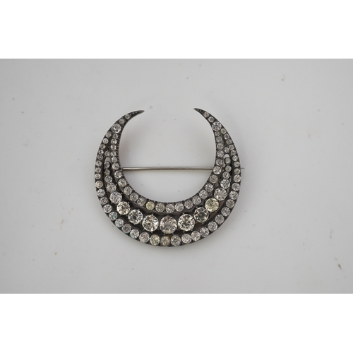 200 - A paste brooch, 19th century, designed as a crescent moon, set with circular-cut pastes in closed se... 