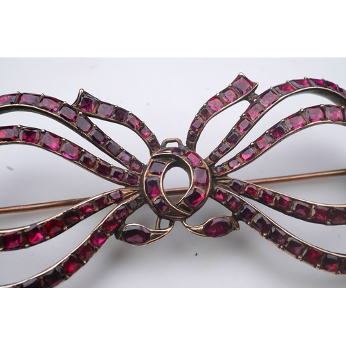 201 - A garnet brooch, late 18th/early 19th century designed as a ribbon bow, set with table-cut garnets i... 