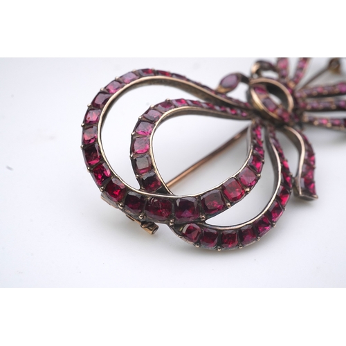 201 - A garnet brooch, late 18th/early 19th century designed as a ribbon bow, set with table-cut garnets i... 