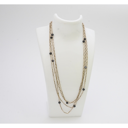 204 - An elegant onyx longchain necklace, early 20th century, composed of elongated belcher linking in gol... 