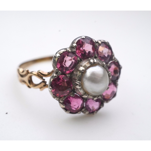 207 - A pearl and pink tourmaline ring, of cluster design, centring on a pearl within a border of circular... 