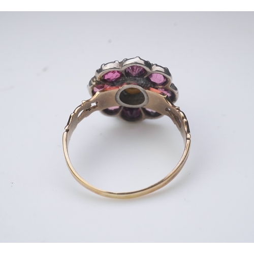 207 - A pearl and pink tourmaline ring, of cluster design, centring on a pearl within a border of circular... 