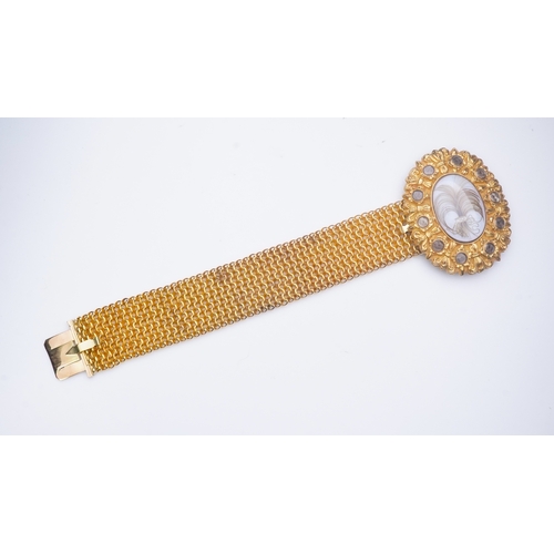 212 - A fine sentimental Georgian gold and hairwork bracelet, 1820s, the oval clasp centring on a glazed c... 