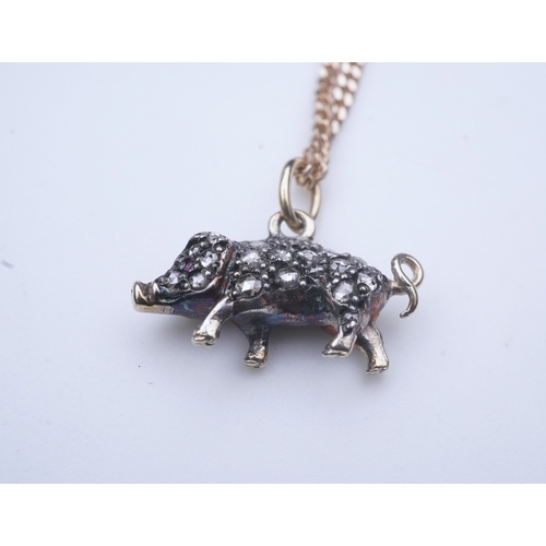 215 - A diamond pendant, designed as a pig, set with rose-cut diamonds, its eye set with a ruby, to a late... 