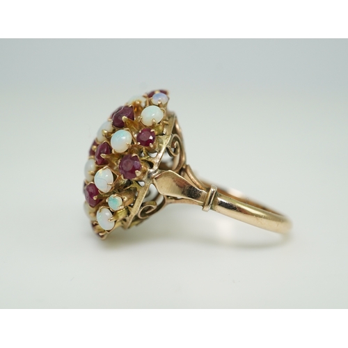 220 - A ruby and opal cocktail ring, mid 20th century, designed as a bombé cluster of circular-cut rubies ... 