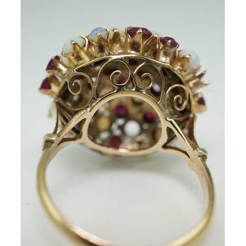 220 - A ruby and opal cocktail ring, mid 20th century, designed as a bombé cluster of circular-cut rubies ... 