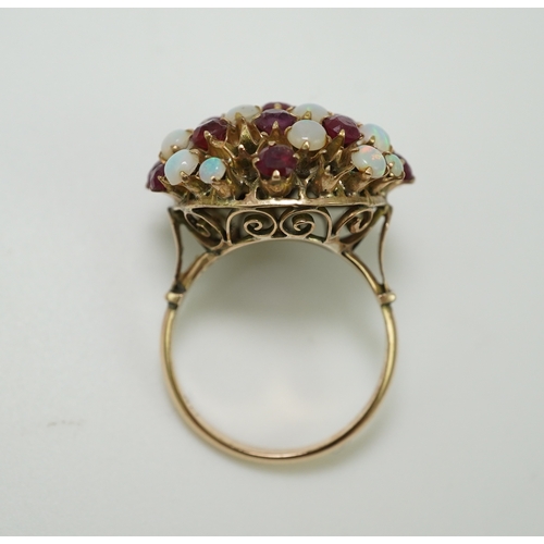 220 - A ruby and opal cocktail ring, mid 20th century, designed as a bombé cluster of circular-cut rubies ... 