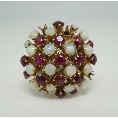 220 - A ruby and opal cocktail ring, mid 20th century, designed as a bombé cluster of circular-cut rubies ... 