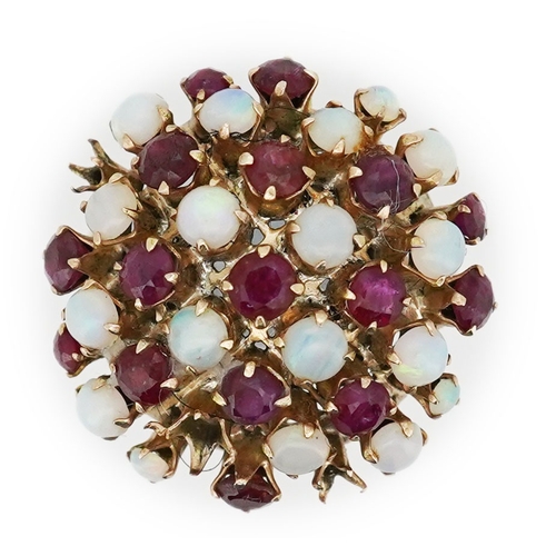 220 - A ruby and opal cocktail ring, mid 20th century, designed as a bombé cluster of circular-cut rubies ... 