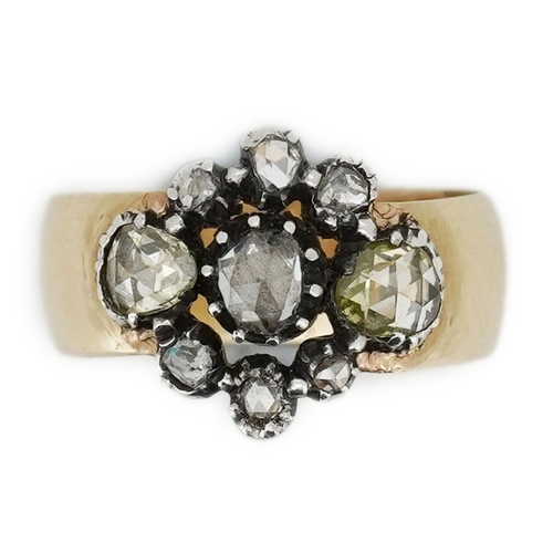 222 - A gold and diamond ring, centering on a cluster of rose-cut diamonds mounted in silver, to a wide 9c... 