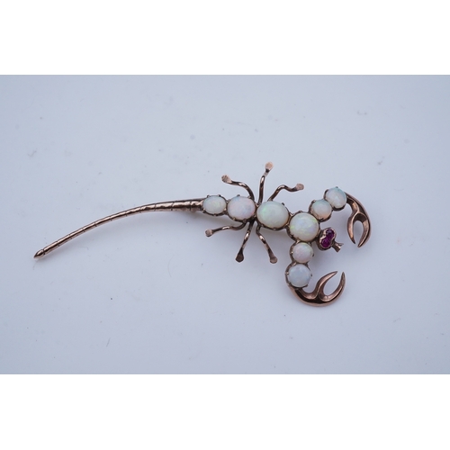 225 - An opal brooch, mid 20th century, designed as a scorpion, its body set with cabochon opals, its eyes... 